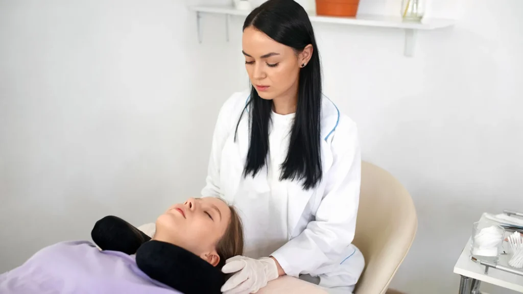 A women giving massage to a women laying on bed